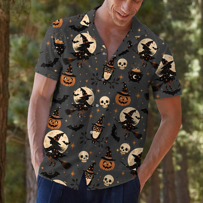 Person modeling Halloween shirt with witch, owl, pumpkin, and bat pattern
