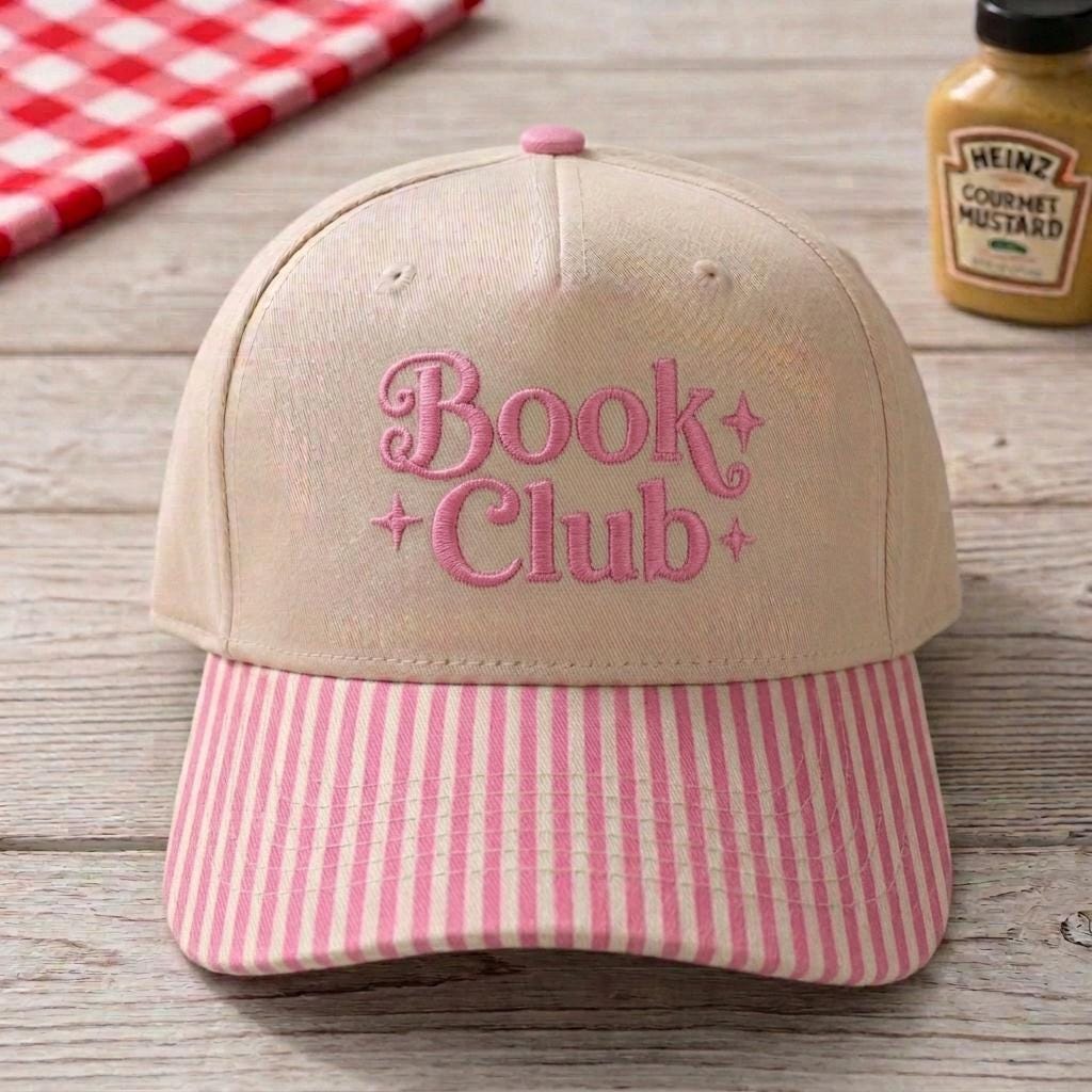 Khaki Book Club embroidered hat with pink lettering and pink striped brim
