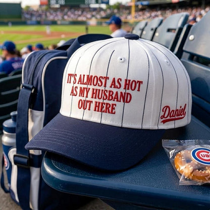 Pinstripe baseball hat displayed in stadium seating with red front lettering