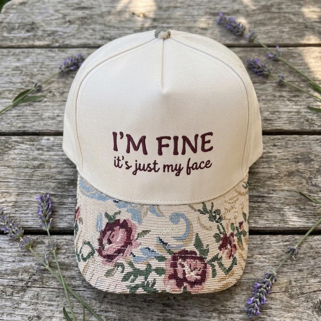Cream statement hat with rose-patterned brim photographed with lavender