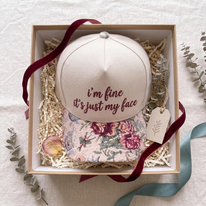 Floral brim embroidered hat presented in a decorative gift box