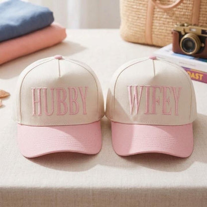 Matching pink Hubby Wifey couple hats on a table
