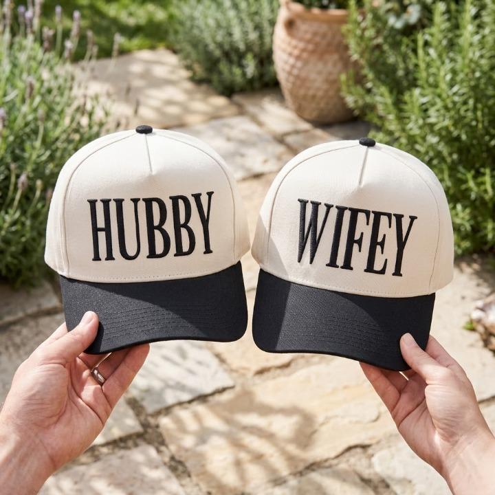Matching black and cream Hubby Wifey couple hats held outdoors