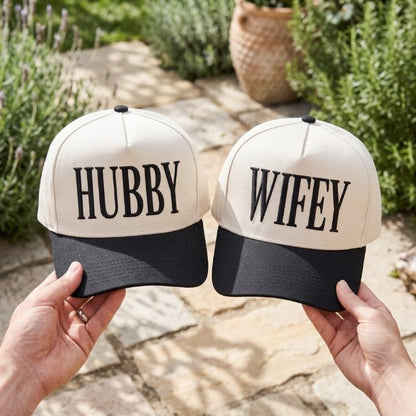 Matching black and cream Hubby Wifey couple hats held outdoors