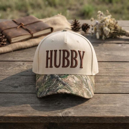 Front view of cream Hubby hat with brown embroidery and camouflage bill