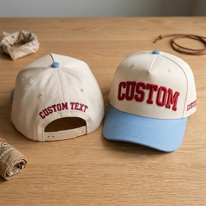 Custom cream baseball cap with light blue brim and bold red lettering