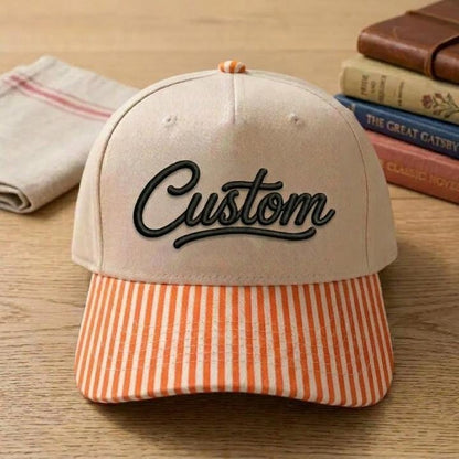 Khaki hat with black Custom script and orange striped brim