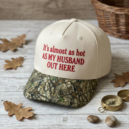 Front view of a light-colored cap with humorous husband-themed embroidery and camo-patterned bill
