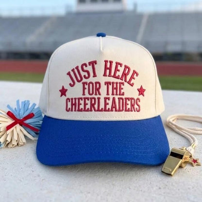 Cheerleader supporter hat with off-white crown and blue brim displayed at a stadium