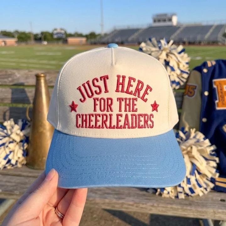 Two-tone cheerleader supporter hat with red embroidered lettering and light blue brim