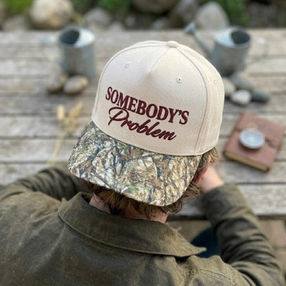 Somebody’s Problem embroidered hat worn from a rear angle with the front design visible
