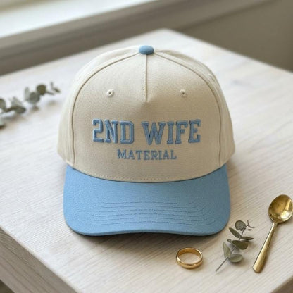 Front view of cream embroidered hat with light blue bill and 2ND WIFE MATERIAL text