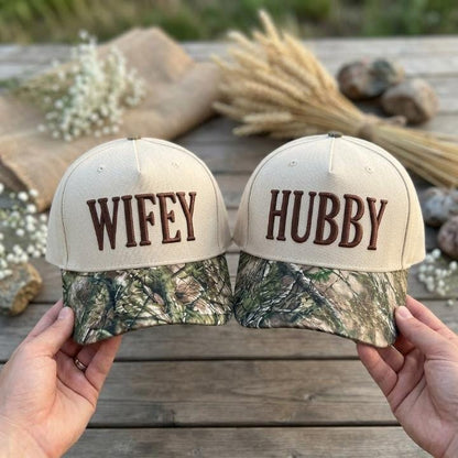 Matching Wifey and Hubby hats with cream crowns and camouflage-print bills