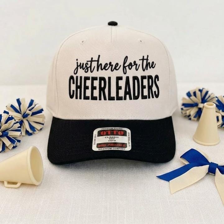 Cream and black cheerleader hat with bold front lettering