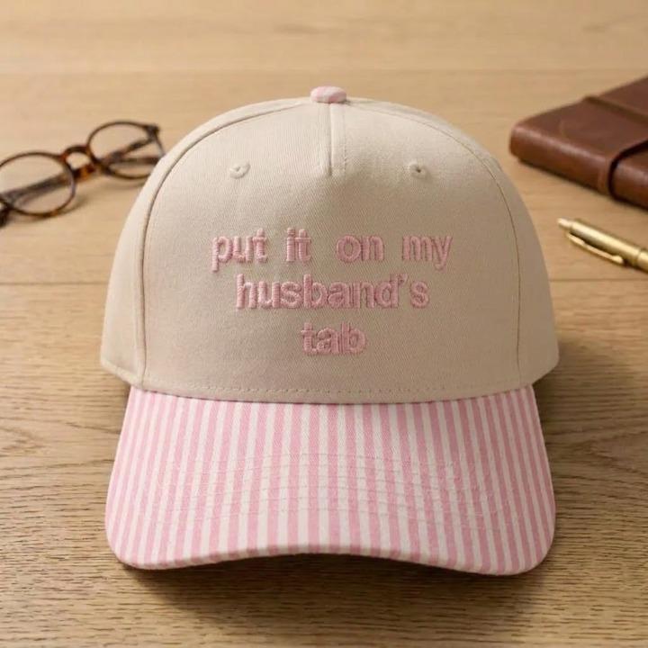 Khaki baseball cap with pink striped brim and matching pink embroidered text