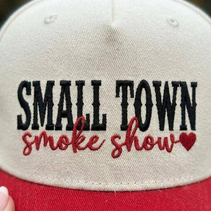 Close-up of Small Town Smoke Show embroidery with red script and heart detail