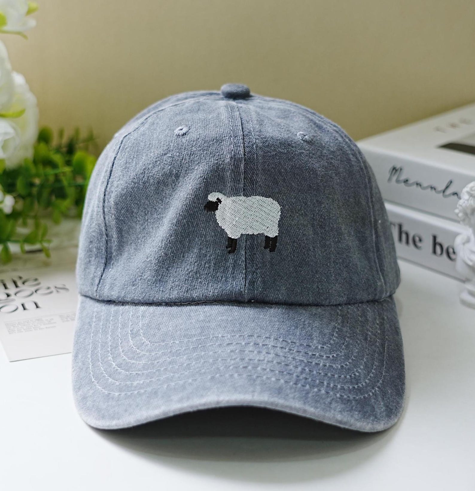 Light blue washed dad hat with minimalist embroidered black-faced sheep – cozy and cute farm-inspired accessory