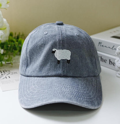 Light blue washed dad hat with minimalist embroidered black-faced sheep – cozy and cute farm-inspired accessory