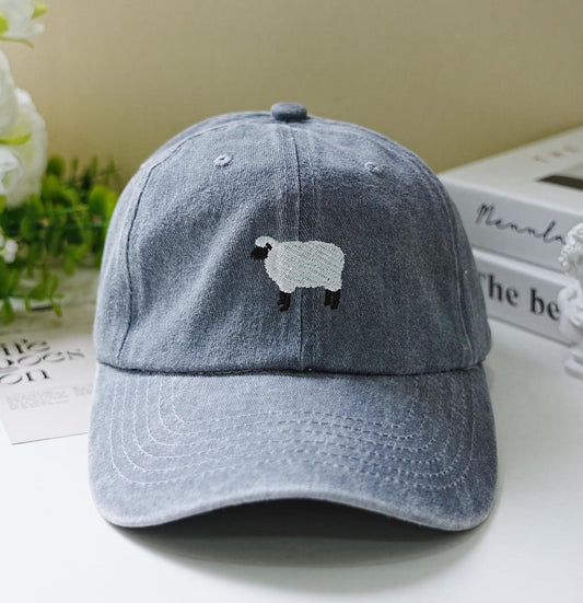 Light blue washed dad hat with minimalist embroidered black-faced sheep – cozy and cute farm-inspired accessory