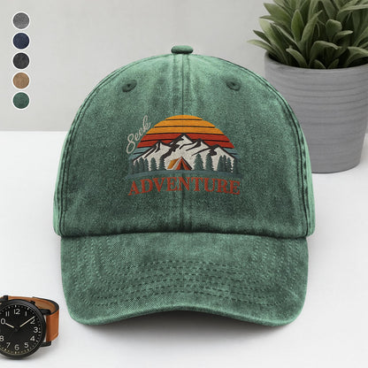 Green washed dad cap embroidered with “Seek Adventure,” mountain sunset, trees, and tent – perfect for campers and outdoor lovers