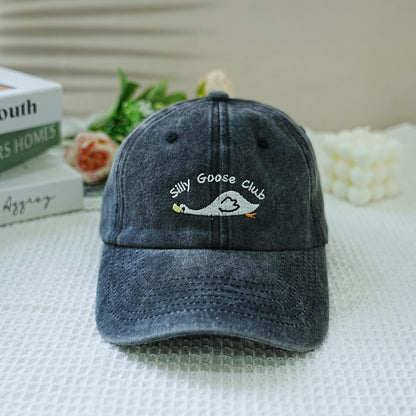 Washed black dad hat with embroidered goose and “Silly Goose Club” text – playful and funny accessory
