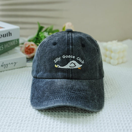 Washed black dad hat with embroidered goose and “Silly Goose Club” text – playful and funny accessory