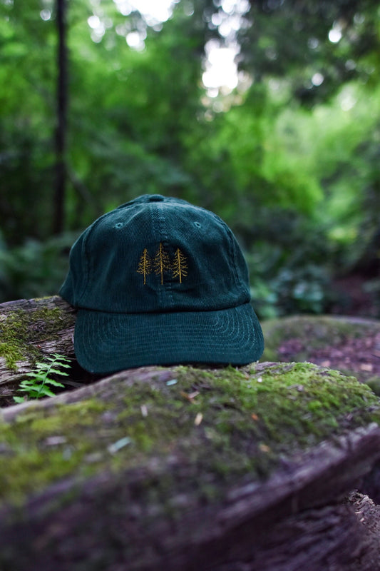 Forest green corduroy dad hat with minimalist embroidered three pine trees – cozy outdoor style for forest lovers